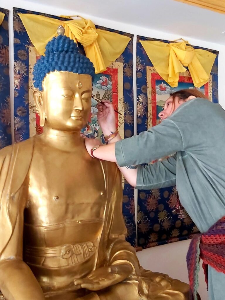 A 16. Karmapát ábrázoló tibeti szobor festése